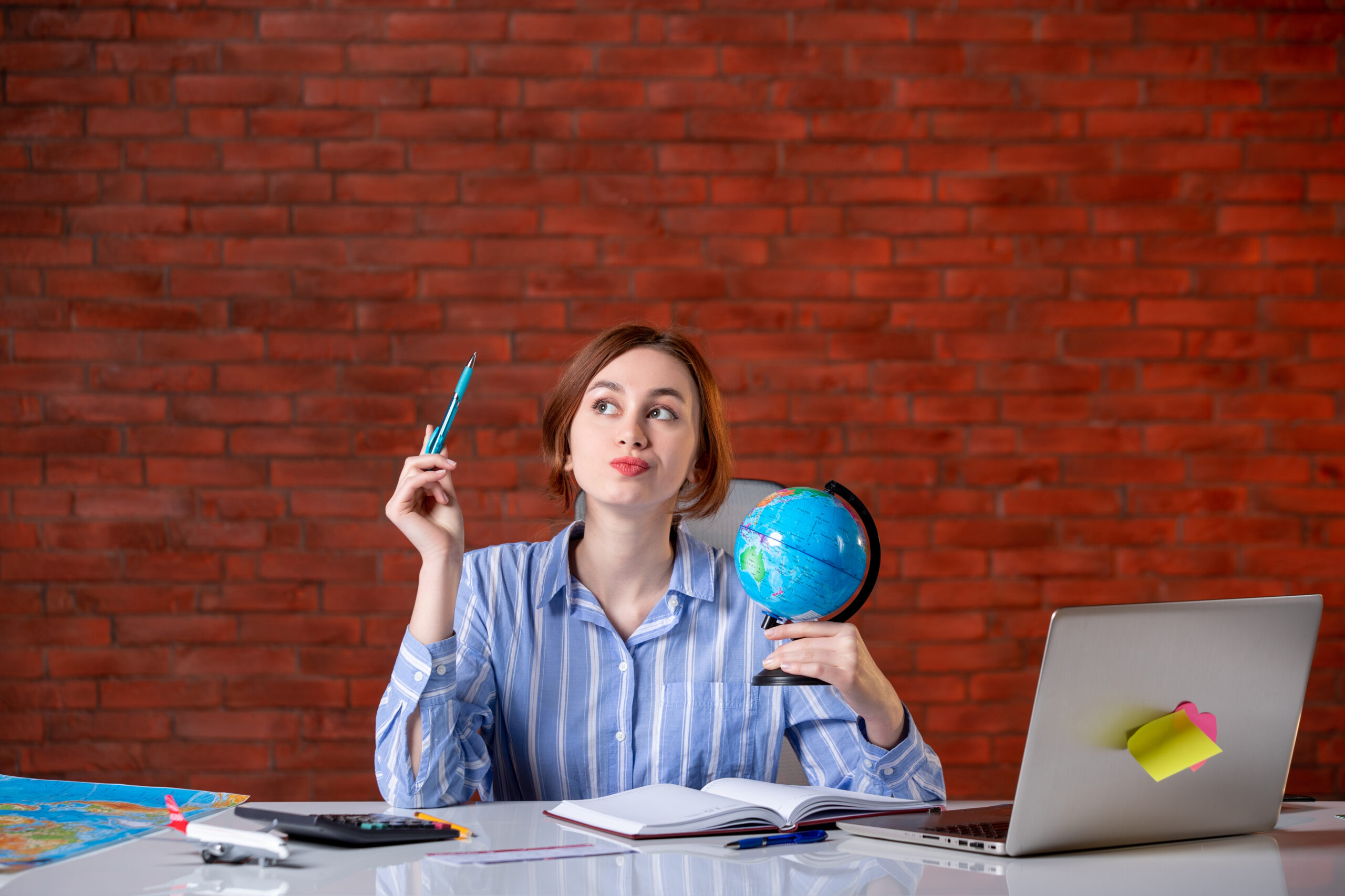 front view travel agent sitting her working place with little globe assistant agency map indoors operator service world managers scaled