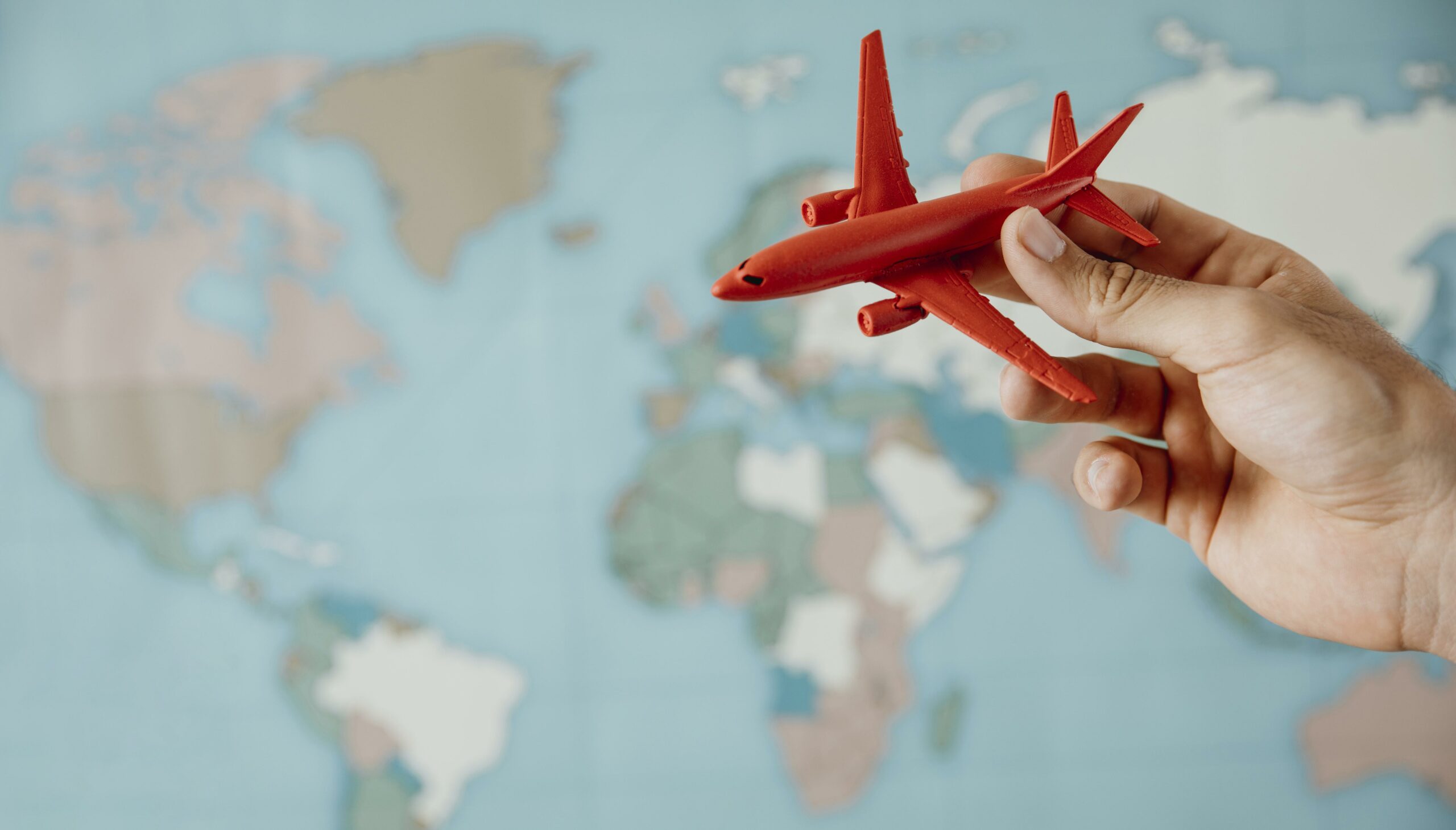 side view person holding airplane figurine map 1 scaled